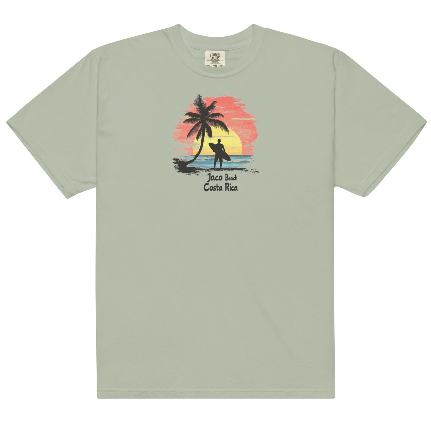 Brown T Shirt Silhouette of a surfer with a board standing by a palm tree, Jaco Beach Costa Rica sunset in the background, ocean waves and beach scene.