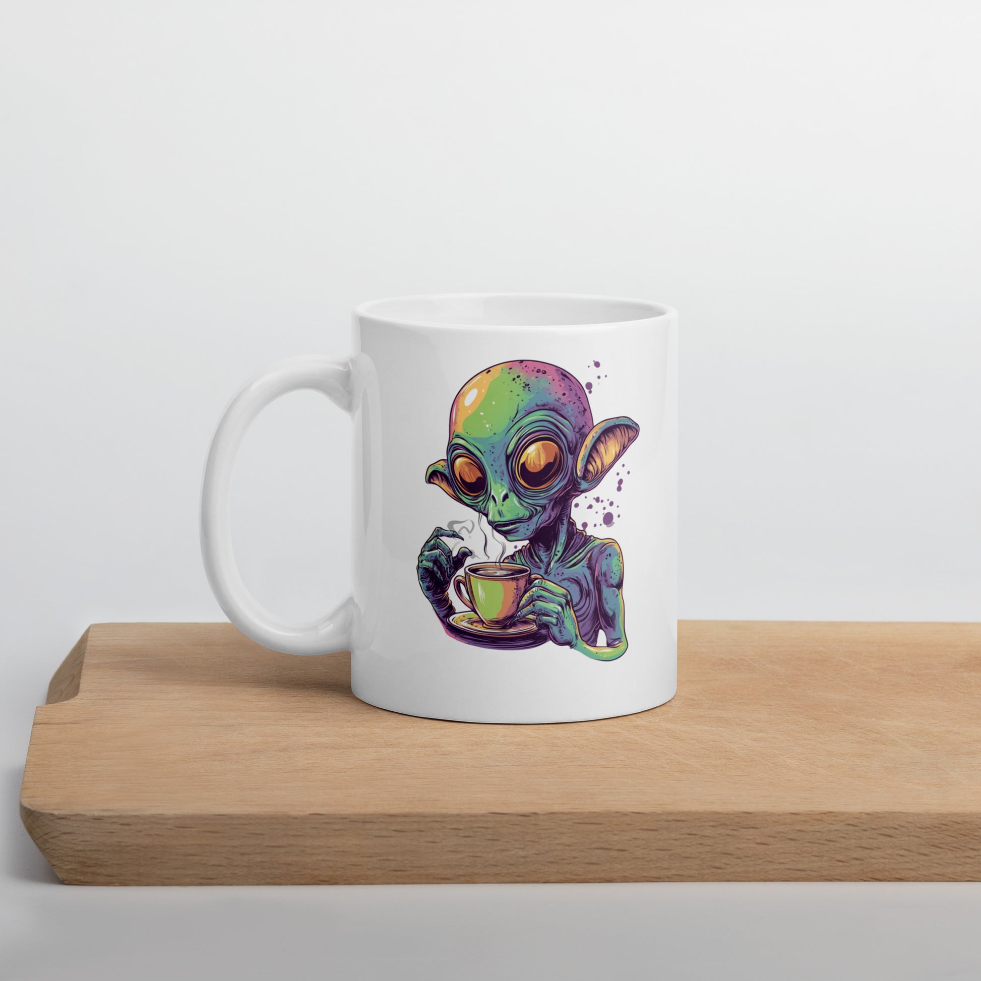 Quirky alien drinking a steaming cup of coffee, colorful sci-fi design on a white background, perfect for coffee lovers and sci-fi fans.